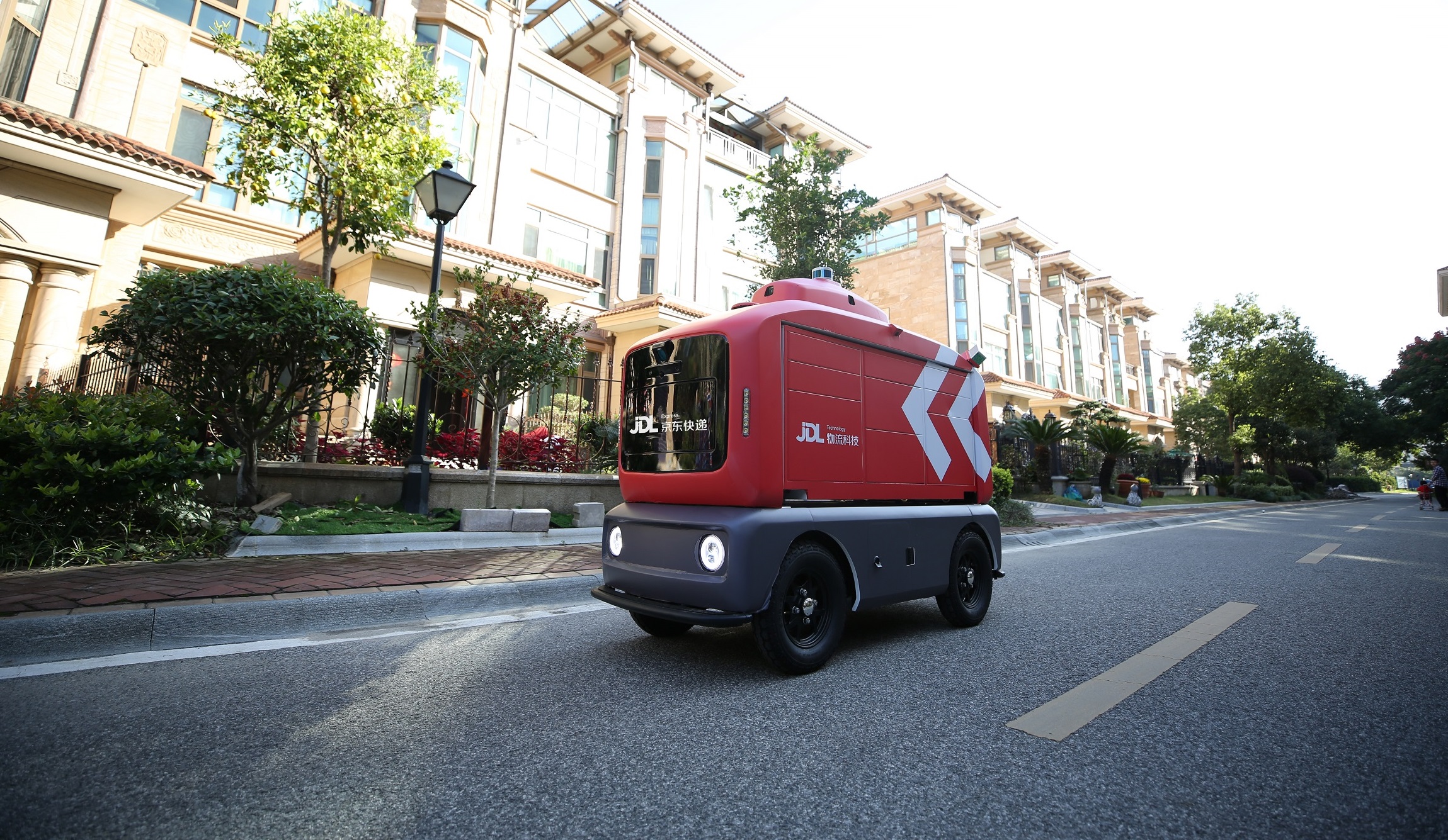 JD.com logistics worker loading packages onto a delivery robot
